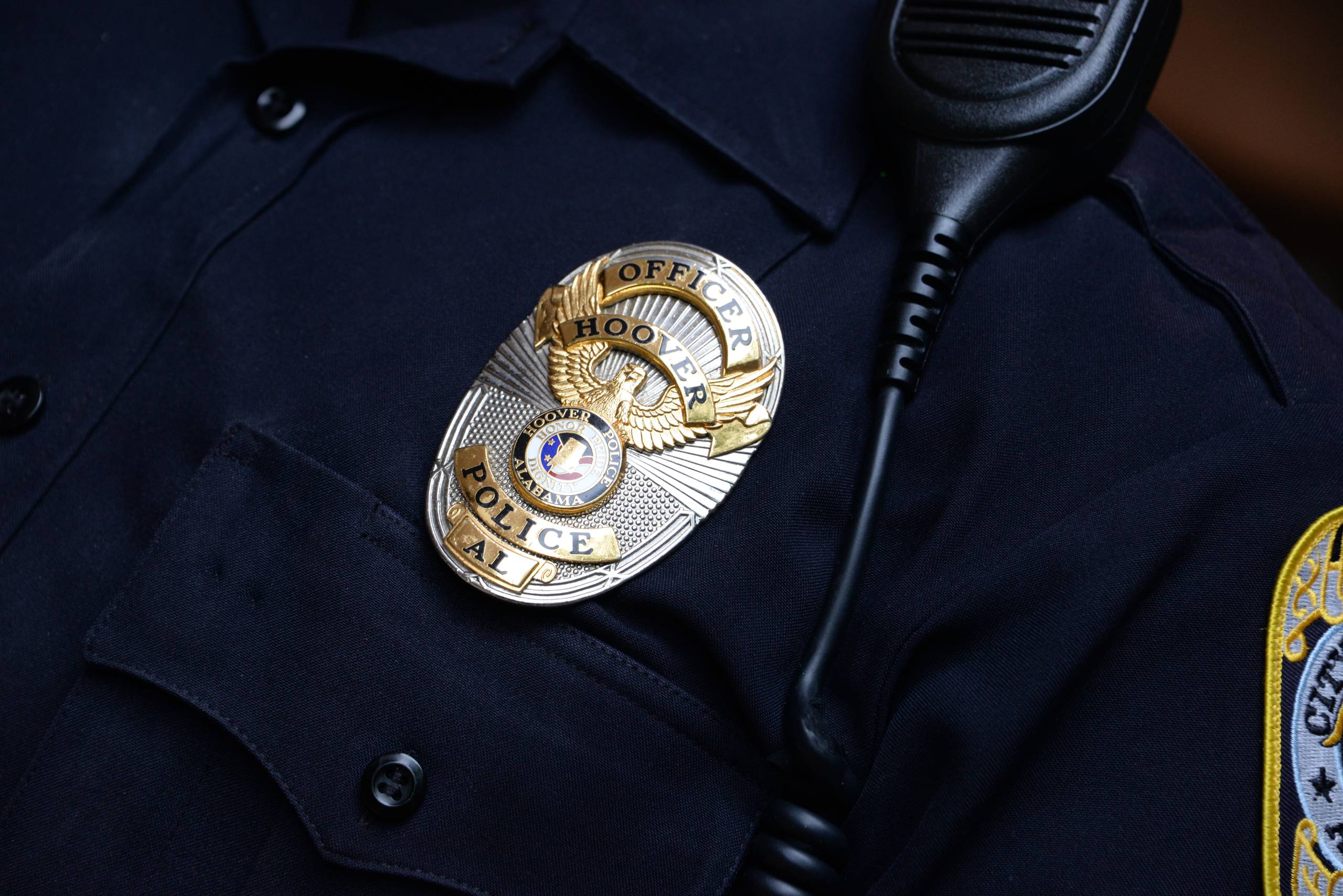 badge on officer closeup scaled